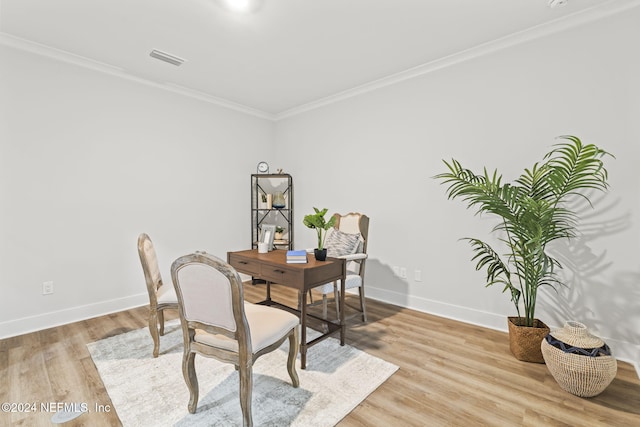 home office featuring crown molding and light hardwood / wood-style floors