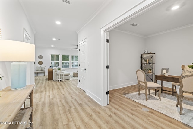 office space featuring crown molding, ceiling fan, and light hardwood / wood-style floors