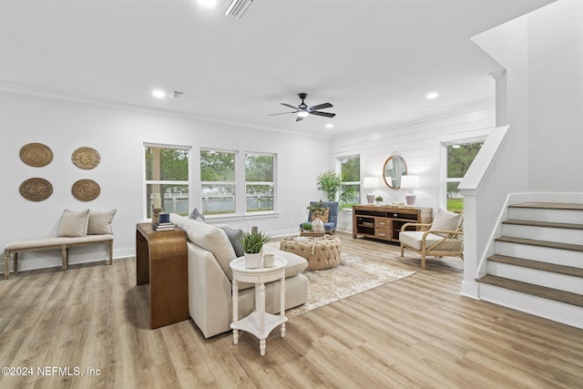 living room featuring crown molding, ceiling fan, and light wood-type flooring