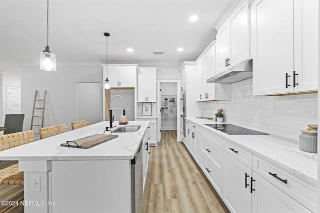 kitchen with sink, a breakfast bar area, white cabinetry, hanging light fixtures, and stainless steel appliances