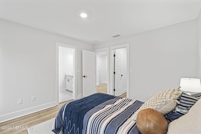 bedroom featuring wood-type flooring and ensuite bathroom