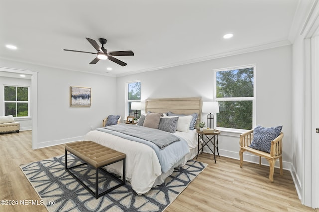 bedroom featuring ornamental molding, ceiling fan, and light hardwood / wood-style floors