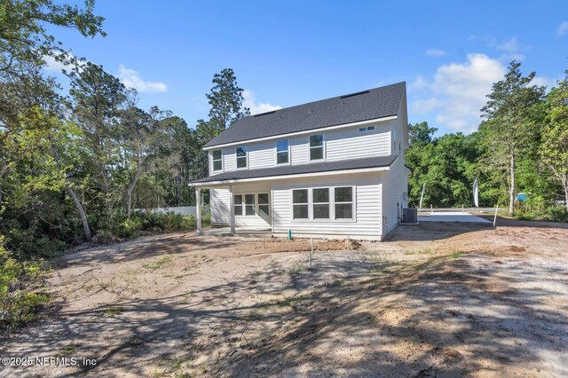 rear view of house with central AC unit