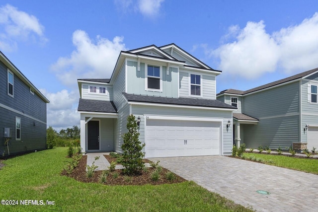 view of front of home with a garage and a front lawn