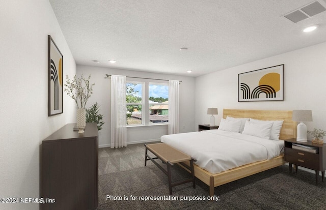 bedroom with carpet and a textured ceiling