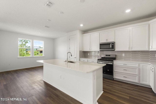 kitchen featuring white cabinetry, sink, stainless steel appliances, and a center island with sink