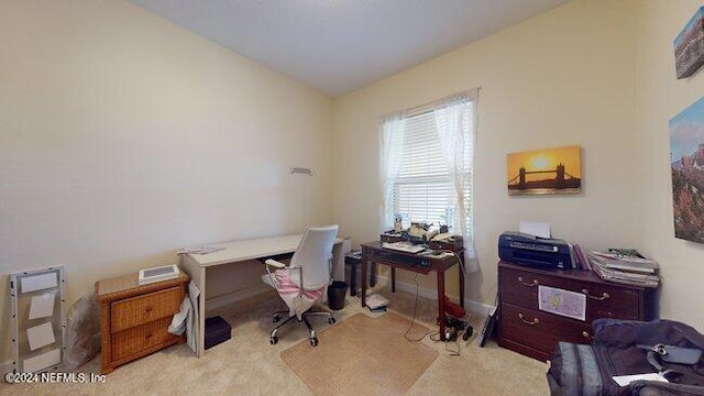 carpeted home office featuring vaulted ceiling