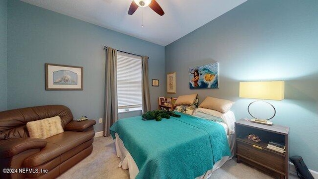 bedroom with lofted ceiling, light carpet, and ceiling fan