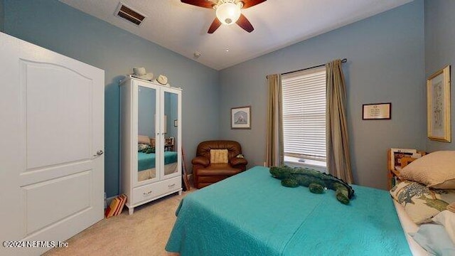 bedroom featuring light colored carpet and ceiling fan