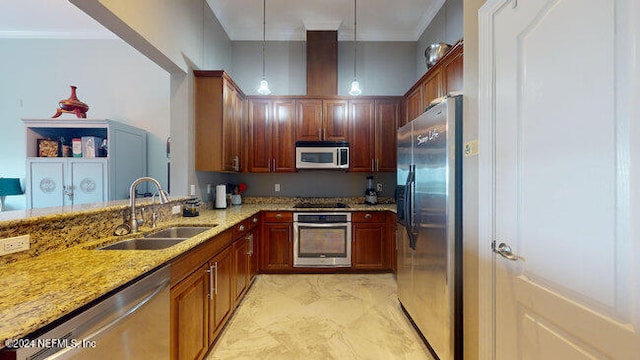 kitchen with pendant lighting, sink, appliances with stainless steel finishes, ornamental molding, and light stone countertops