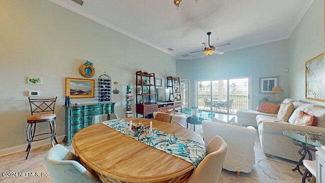 dining area with ornamental molding and ceiling fan