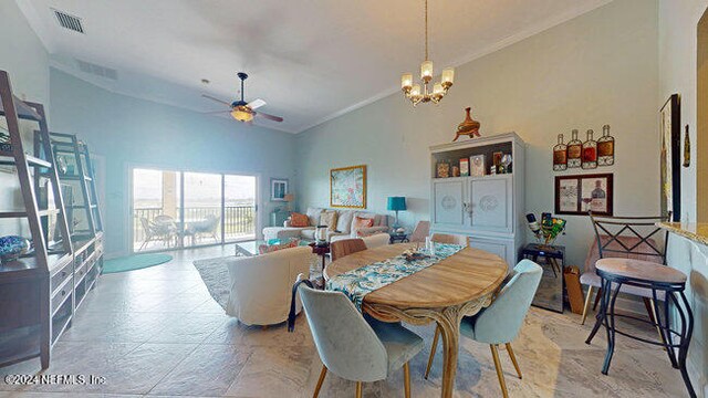 dining area with ceiling fan with notable chandelier, ornamental molding, and high vaulted ceiling