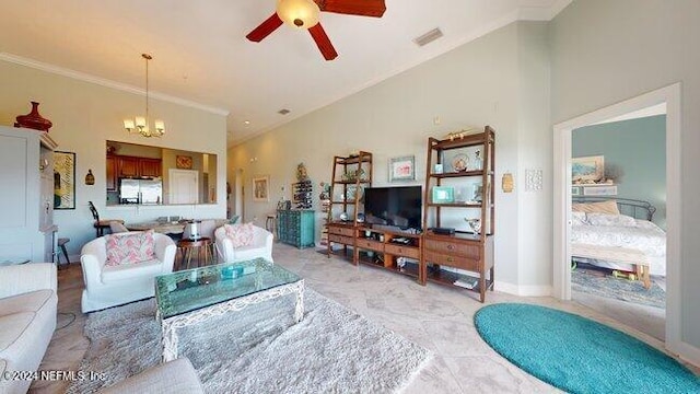 living room with lofted ceiling, ceiling fan with notable chandelier, and ornamental molding