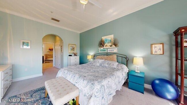 carpeted bedroom featuring crown molding and ceiling fan