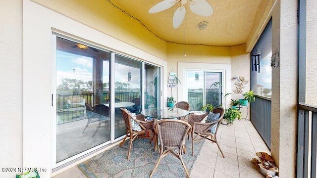 sunroom featuring ceiling fan