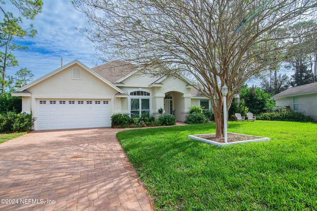 ranch-style house with a garage and a front lawn