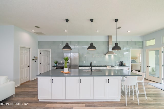 kitchen with white cabinets, sink, light wood-type flooring, and stainless steel appliances