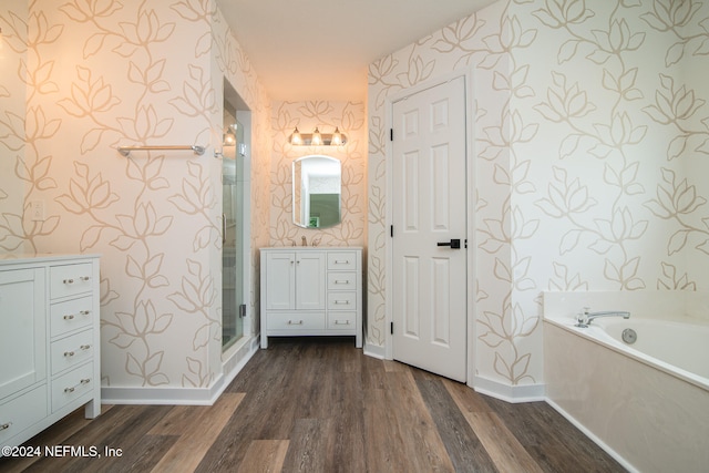 bathroom featuring wood-type flooring, vanity, and shower with separate bathtub