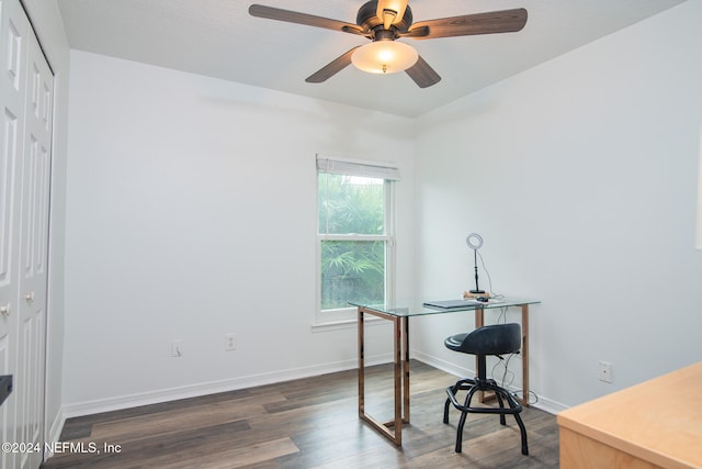 home office with ceiling fan and dark hardwood / wood-style flooring