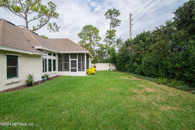 view of yard with a sunroom