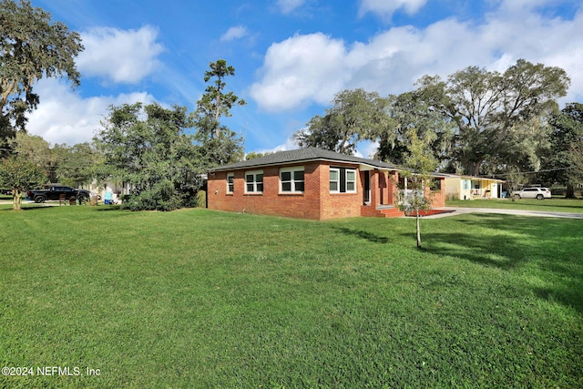 view of side of home featuring a lawn