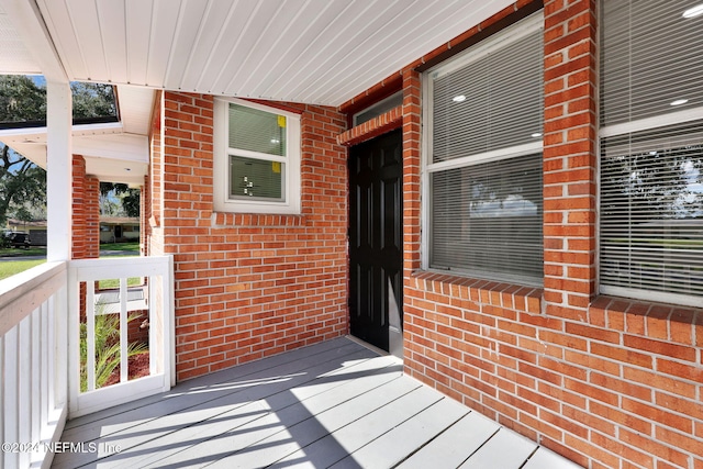 view of exterior entry featuring a porch