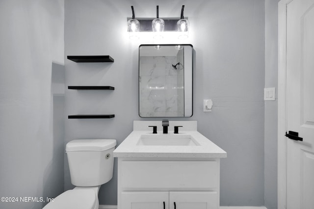 bathroom with vanity, toilet, and walk in shower