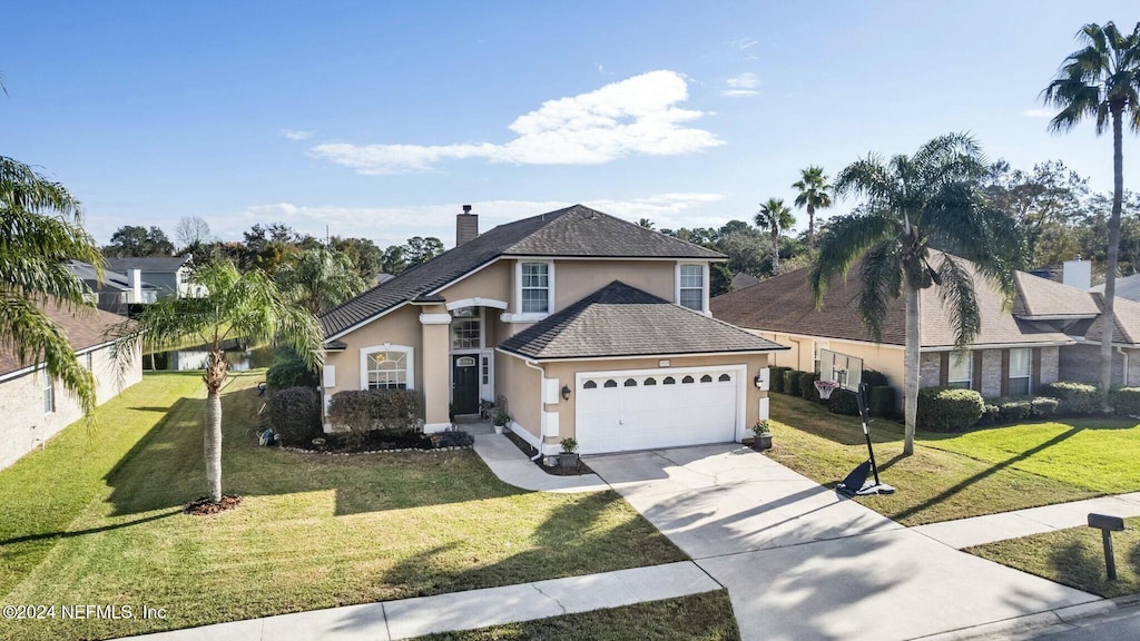 view of property featuring a garage and a front yard