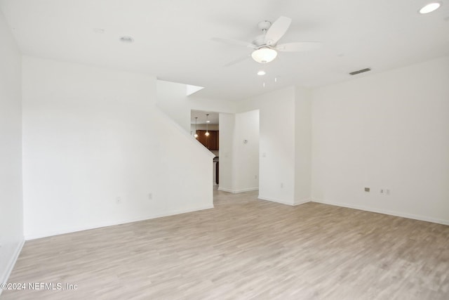 empty room featuring light hardwood / wood-style flooring and ceiling fan