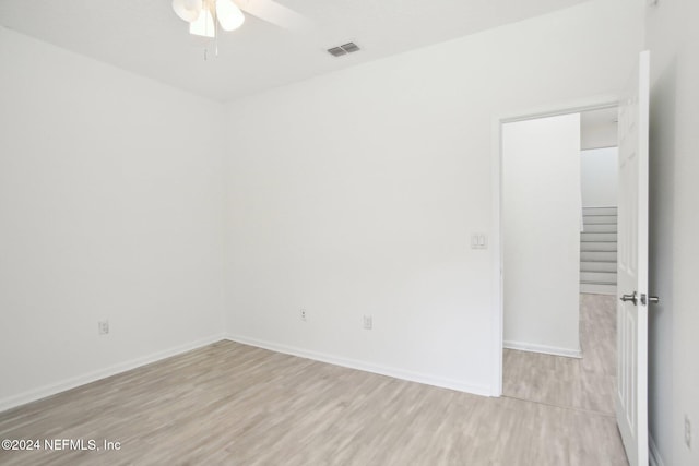 empty room featuring light hardwood / wood-style flooring and ceiling fan