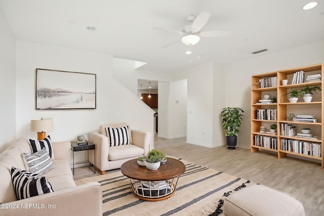 living room featuring light wood-type flooring and ceiling fan