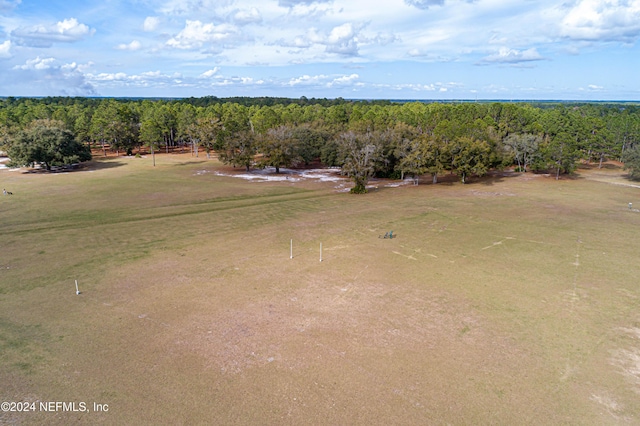 bird's eye view featuring a wooded view