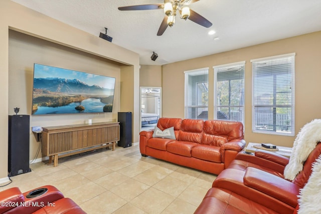 tiled living room with ceiling fan and a textured ceiling