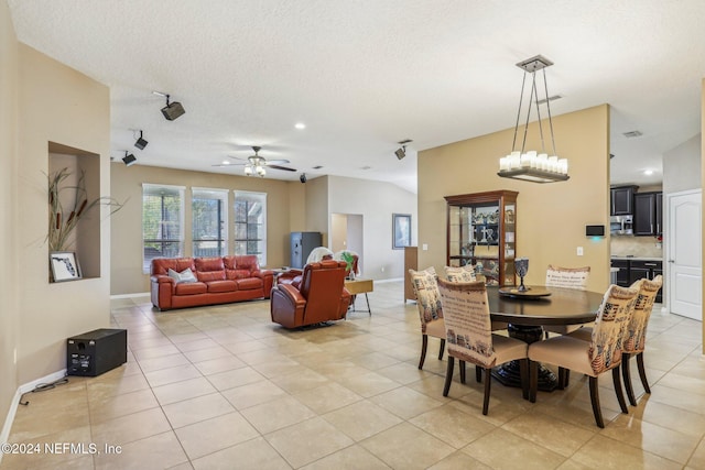 dining room featuring light tile patterned floors, a textured ceiling, and ceiling fan