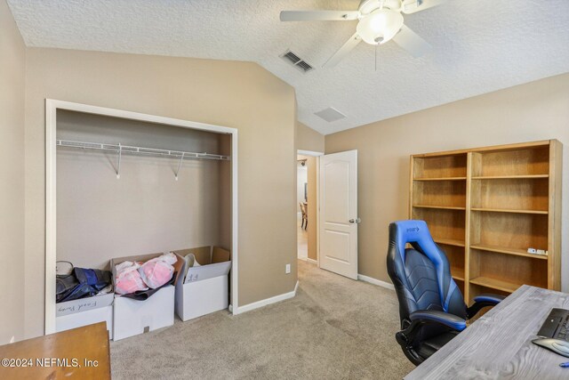 office with lofted ceiling, light carpet, ceiling fan, and a textured ceiling