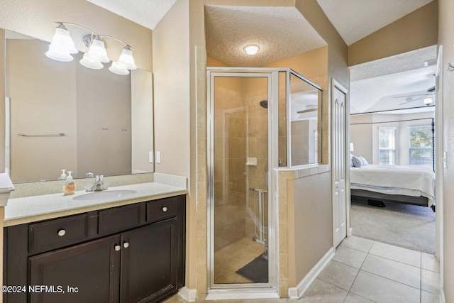 bathroom with tile patterned flooring, a shower with door, a textured ceiling, and vaulted ceiling