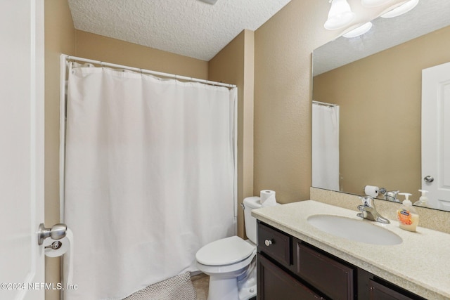 bathroom with a shower with curtain, vanity, a textured ceiling, and toilet