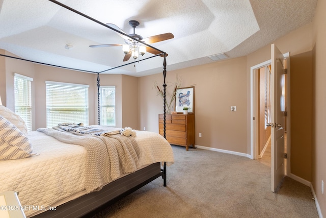 bedroom with a textured ceiling, visible vents, baseboards, ceiling fan, and light carpet