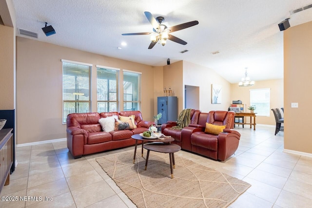 living room with light tile patterned floors, visible vents, and lofted ceiling