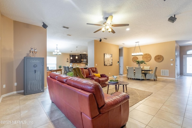 living area with a wealth of natural light, visible vents, and light tile patterned floors