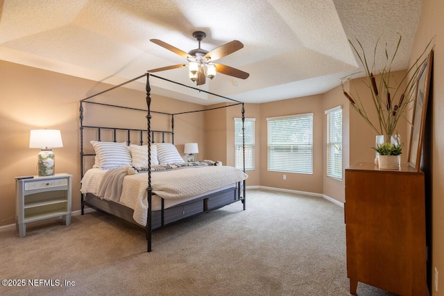 bedroom featuring a textured ceiling, ceiling fan, baseboards, and light carpet