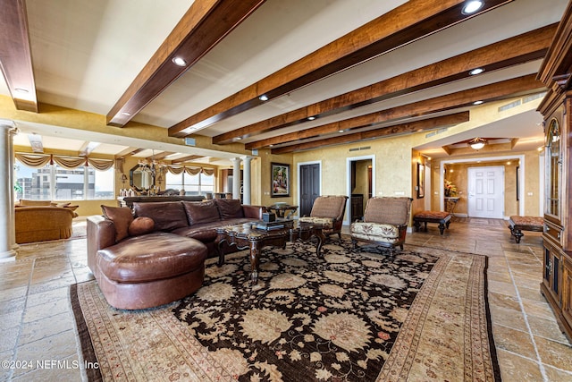 living room with beamed ceiling and ornate columns