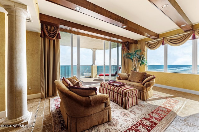 sunroom / solarium featuring beam ceiling, a water view, and ornate columns