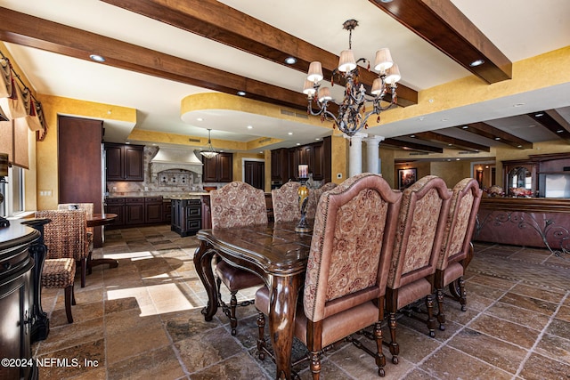 dining space featuring beamed ceiling, ornate columns, and a chandelier