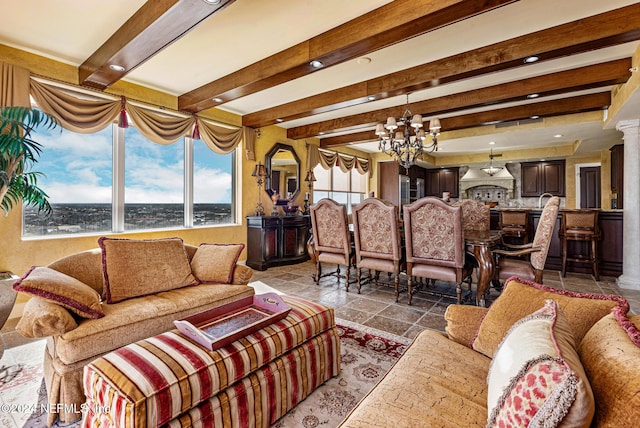 living room featuring decorative columns, beamed ceiling, and a chandelier