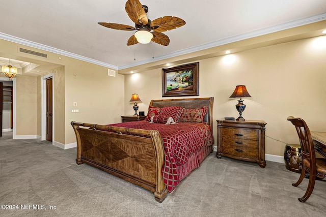 carpeted bedroom with ceiling fan and ornamental molding