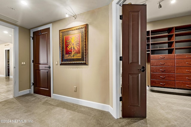 hall with light colored carpet