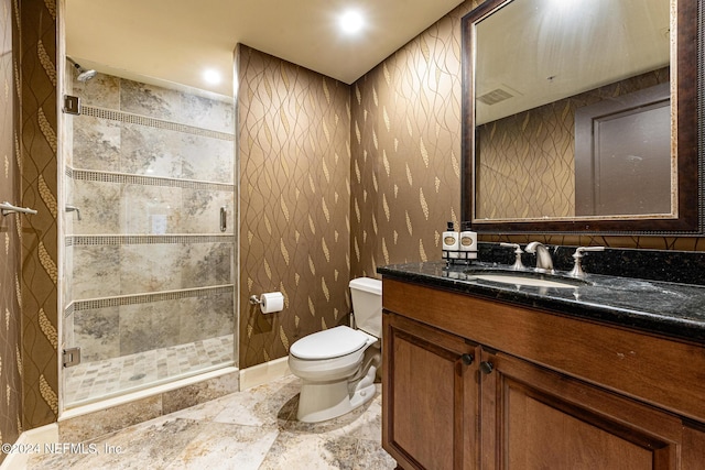 bathroom with vanity, toilet, and walk in shower