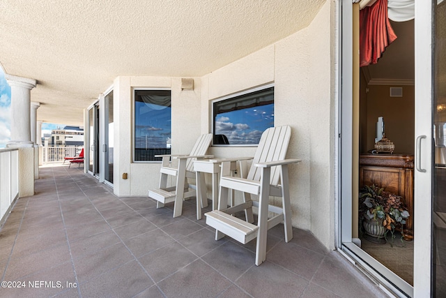 view of patio featuring a balcony