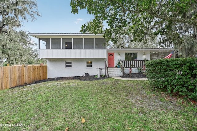 split level home with a sunroom and a front yard